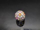 a close up of a ring on a table with a black background