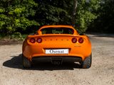 an orange sports car that is parked on the side of the road