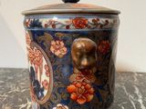 an image of a blue and red vase with a lion head on it