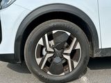 a close up of a tire on a white car
