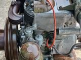 a small engine that is sitting on a wooden stand