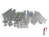 a lot of glasses and cups sitting on a table