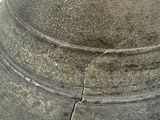 a close up of a stone vase on a white surface