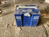 a blue box sitting on the ground in a room
