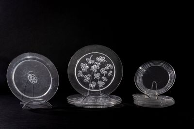 three glass plates sitting on top of a black table