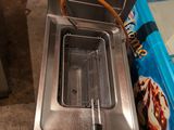 a deep fryer that is sitting on the floor