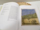an open book with a picture of a landscape on it
