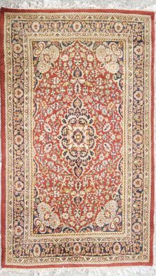 a red and black rug with a medallion design on it