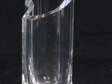 a clear glass vase sitting on a black surface