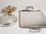 a silver tray with a mirror and a teapot on it