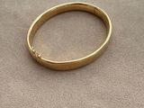 a close up of a gold ring on a carpeted surface