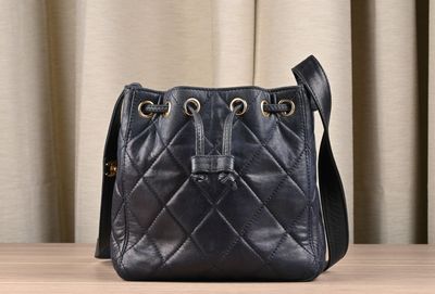 a black purse sitting on top of a wooden table