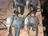several electric tools are sitting on top of a wooden table