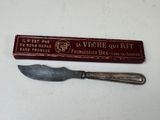 a knife that is sitting next to a box