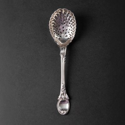 a close up of a spoon on a table with a black background