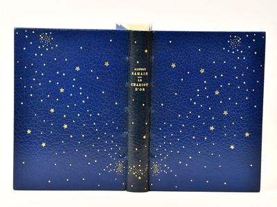 an open blue book with gold stars on it