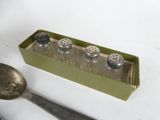 spoon and salt shakers in a box with a spoon and spoon rest on a table