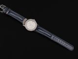an image of a watch with a leather strap on a black background
