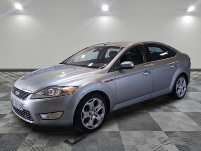 an image of a silver ford monde parked in a garage