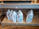 four bottles of detere sitting on a shelf in a store