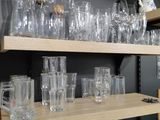 many glasses and mugs on the shelves in the room