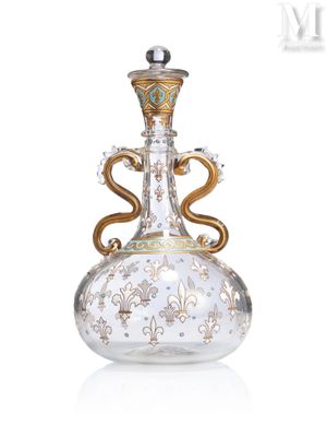 a glass vase with a gold and blue decoration on it
