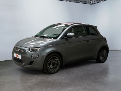 the small car is parked in a large room with white walls