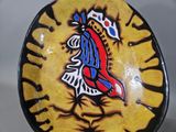 a yellow plate with a picture of a bird on it