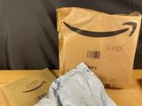 une boîte amazon et deux sacs de nourriture posés sur une table