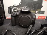 a canon camera sitting on a table next to a box