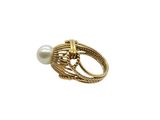 a close up of a gold ring with a pearl on it