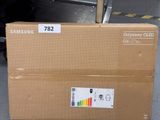 a cardboard box with a sticker on it sitting on the ground