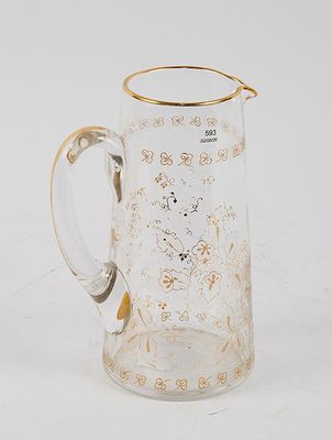 an image of a glass pitcher with a gold rim on a white surface