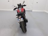a picture of a red and black motorcycle parked in a garage