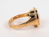 a close up of a gold ring with a diamond in the center