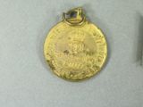 a gold medal and a silver medal on a table