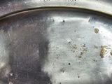 a silver plate with writing on it sitting on a table