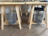 a desk with two chairs and a computer on top of it