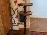 a tall wooden table with a bird design on it