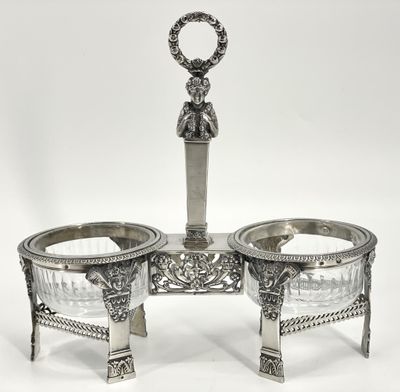 a silver plate with two bowls and a spoon on top of it
