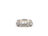 a close up of a ring with three diamonds on it