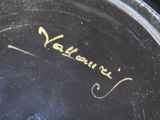 a close up of a black plate with writing on it