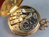 a close up of a pocket watch on a table