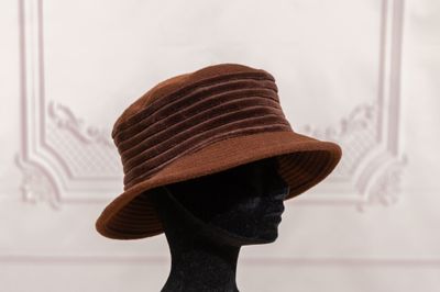a mannequin wearing a brown hat on a mannequin head