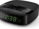 a black alarm clock sitting on top of a white surface