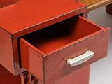 a red desk with a drawer on top of it