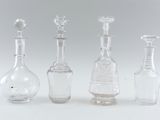 three clear glass bottles sitting next to each other on a white surface