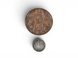 a close up of a coin and a coin on a white surface