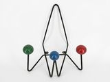 a close up of a metal rack with three balls on it