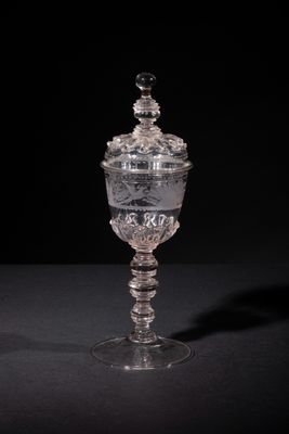 an old fashioned glass cup with a lid on a black surface
